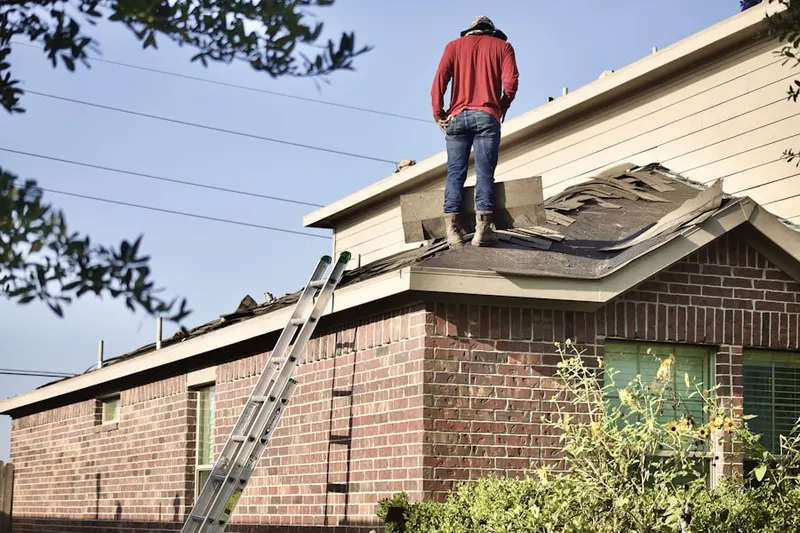 Professional roofer working on a residential roof in Charleston Afb